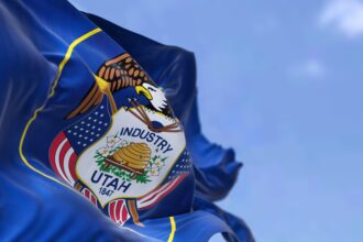 The US state flag of Utah waving in the wind