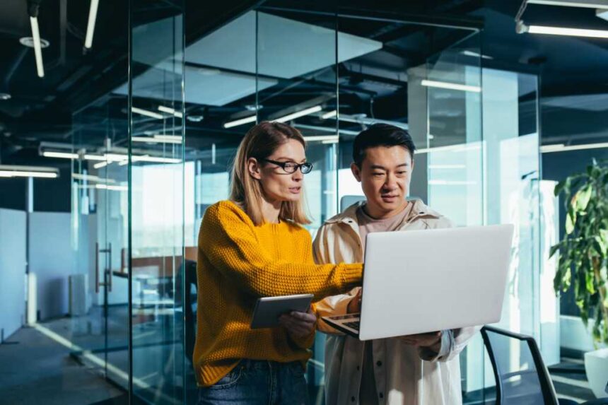 man woman looking at computer