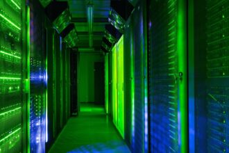 Data center server room lit with green lights