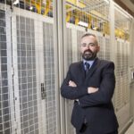 Danny Quinn, Managing Director of Scottish data center provider, DataVita, pictured next to data center racks