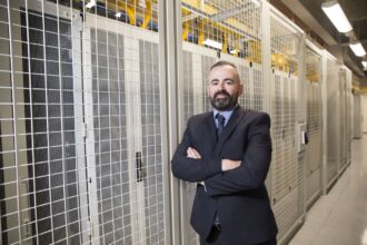 Danny Quinn, Managing Director of Scottish data center provider, DataVita, pictured next to data center racks