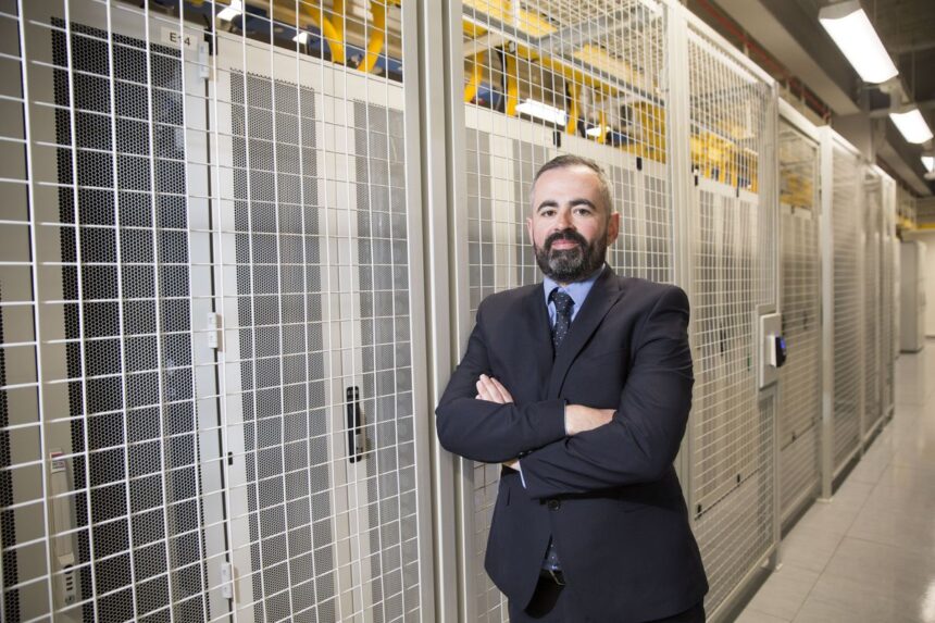 Danny Quinn, Managing Director of Scottish data center provider, DataVita, pictured next to data center racks