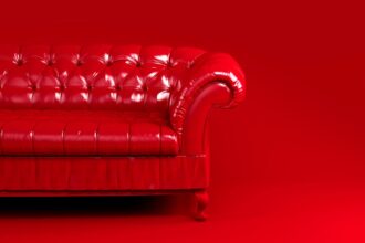 shutterstock 1820130491 red quilted leather sofa on red background