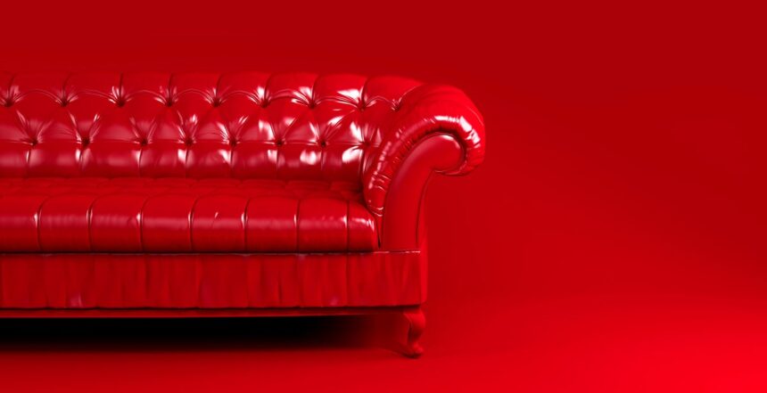 shutterstock 1820130491 red quilted leather sofa on red background