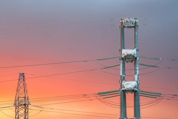 High voltage power transmission line on sunset background