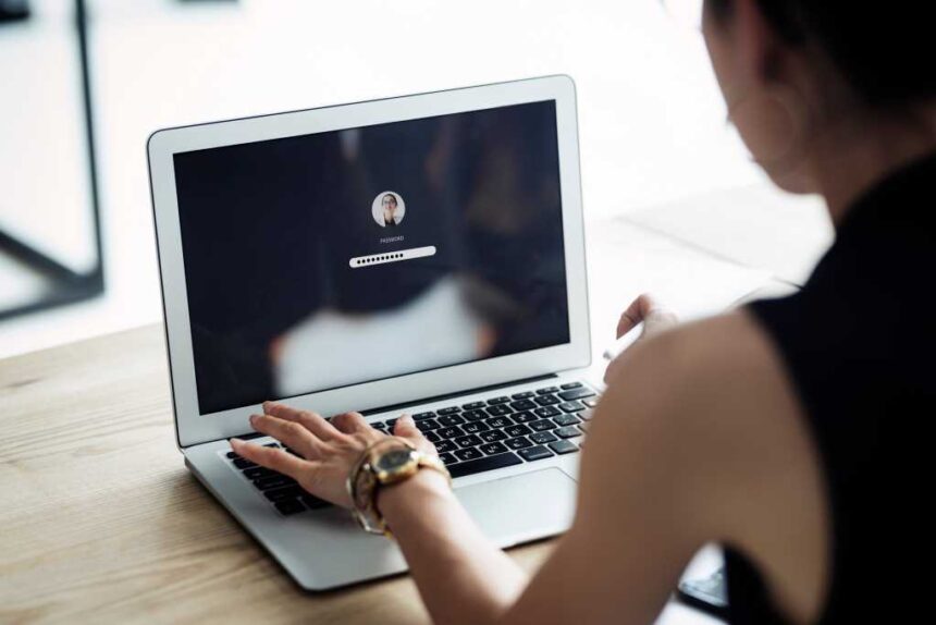 woman logging in to laptop with password