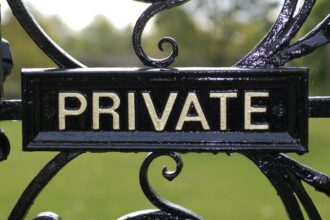 shutterstock 64776670 Private sign on vintage black iron gate with foresty estate in the background