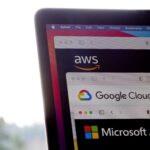 AWS, Google Cloud, and Microsoft Azure logos are seen respectively on the websites of the big three cloud providers on a laptop computer.