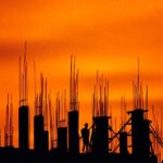 construction site silhouette against orange sky