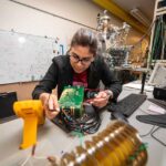 Kaushalya Jhuria in the lab testing the electronics that are part of the experimental setup used for making qubits in silicon.