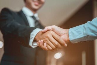 Two businesspeople shaking hands.