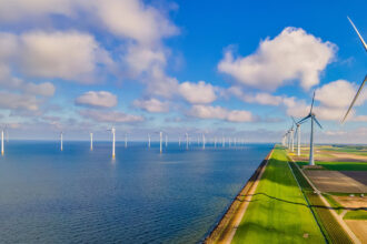 Wind turbines at sea generate green renewable energy in the Netherlands.