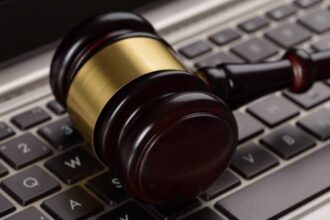 A photograph of a gavel lying sideways on a keyboard.