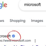 A screenshot taken of Google search displaying a blue checkmark next to a Microsoft weblink.