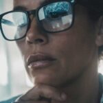 data reflecting on woman’s glasses