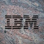 IBM logo on a granite background to illustrate the launch of the company's Granite 3.0 family of AI models alongside an open-source commitment.