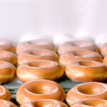 donuts on conveyer belt getting iced