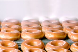 donuts on conveyer belt getting iced