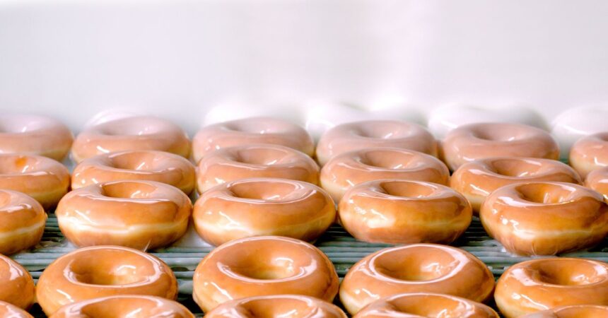 donuts on conveyer belt getting iced