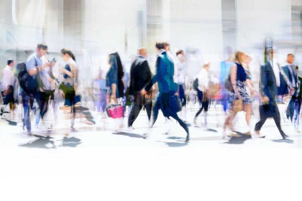 Time-lapse photography of busy pedestrian traffic on a city street.