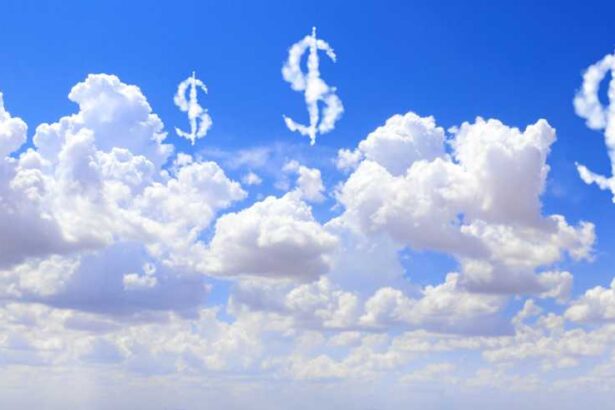 Cloud costs. US dollar signs floating above clouds in the sky. 2166686133