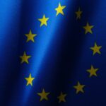 Flag of the EU as the European Commission has seen a flood of interest from companies looking to help create AI Gigafactories across Europe develop and train the next generation of artificial intelligence systems.