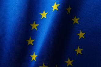 Flag of the EU as the European Commission has seen a flood of interest from companies looking to help create AI Gigafactories across Europe develop and train the next generation of artificial intelligence systems.