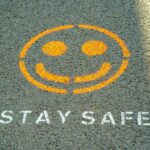 Stay safe written on the floor as Anthropic has detailed its safety strategy to try and keep its popular AI model, Claude, helpful while avoiding perpetuating harms.