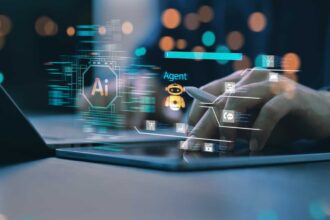 A person at a laptop with a stylus and visual overlay suggestive of AI agent development.