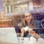 Woman at the cafeteria using technology