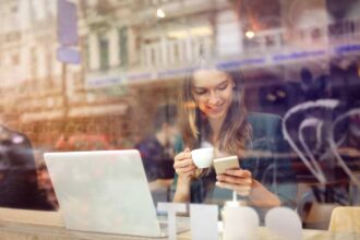 Woman at the cafeteria using technology