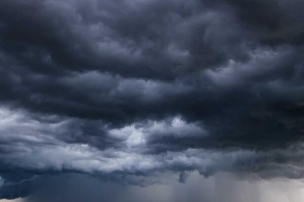Dark sky with heavy clouds converging and a violent storm before the rain. Bad weather stormy weather moody weather ominous clouds.