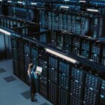 3D Computer Graphics: Data Center Female Chief Technology Officer Using Laptop Standing In Warehouse, Activates Servers, Information Digitalization Starts. SAAS, Cloud Computing, Online Service