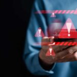 System warning caution sign on smartphone, scam virus attack on firewall for notification error and maintenance. Network security vulnerability, data breach, illegal connection and information danger.