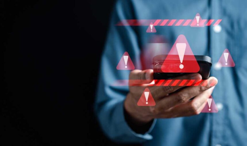 System warning caution sign on smartphone, scam virus attack on firewall for notification error and maintenance. Network security vulnerability, data breach, illegal connection and information danger.