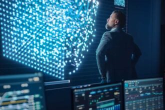 Middle Aged Bearded Senior Project Manager Stands Next to Big Screen with Neural Network. Professional Computer Data Science Engineer Work in a System Control and Monitoring Telecommunications Office
