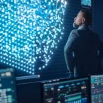 Middle Aged Bearded Senior Project Manager Stands Next to Big Screen with Neural Network. Professional Computer Data Science Engineer Work in a System Control and Monitoring Telecommunications Office