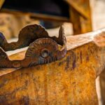 A rusty crown sits on an anvil.