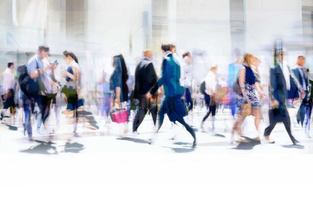 Time-lapse photography of busy pedestrian traffic on a city street.
