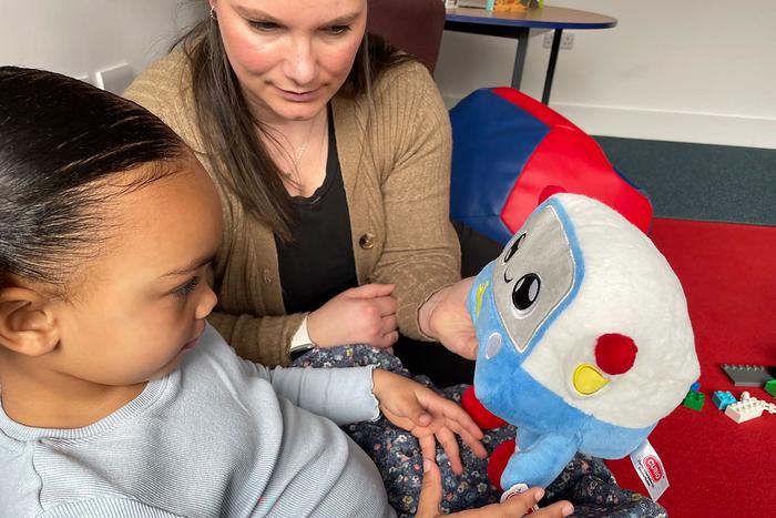 Mya, age 3, and her mum, Vicky, playing with the AI toy, Gabbo, during an observation at the University of Cambridge’s Faculty of Education.