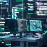 Portrait of Two Diverse Developers Working on Computers, Typing Lines of Code that Appear on Big Screens Surrounding Them. Male and Female Programmers Creating Innovative Software, Fixing Bugs.