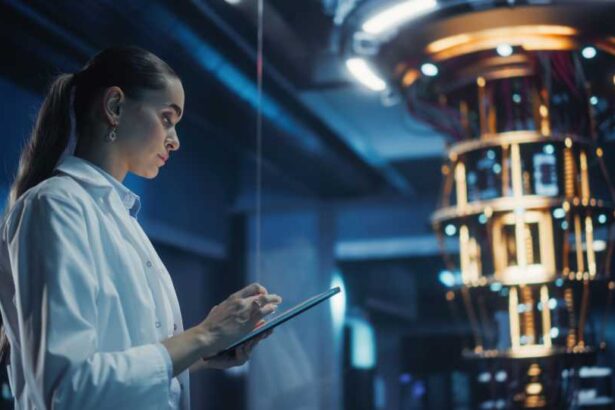 Female Engineer Working on Quantum Computer Hardware, Using Tablet Computer to Access Technical Specifications and Control Processor Parameters. Group of Developers Work on AI Behind a Desk